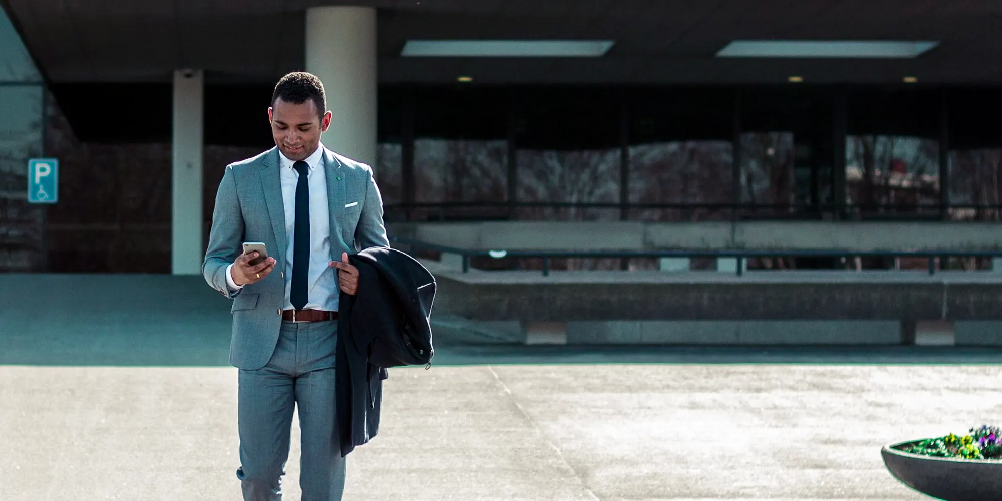 A man walking in front of a Regional Center, learning how EB-5 regional centers streamline investments, create jobs, and can help you achieve U.S. green card eligibility